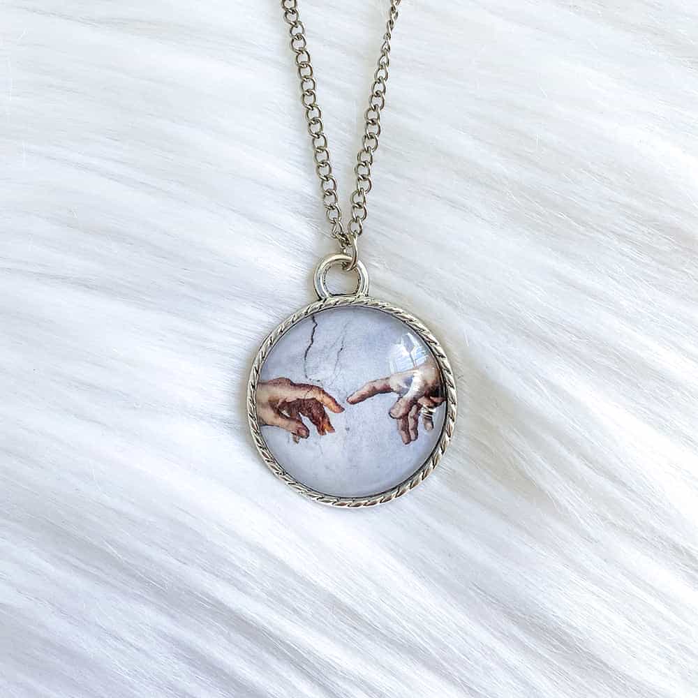 Da Vinci Touching Fingers Glass Necklace Da Vinci Touching Fingers Glass Necklace