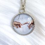 Da Vinci Touching Fingers Glass Necklace